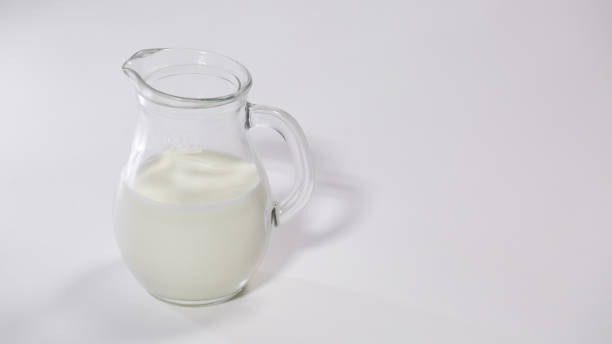 istock glass jug with milk on white background. 660472170