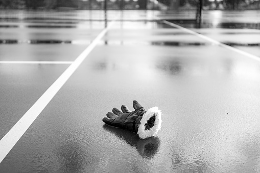 Lost glove on a tennis court