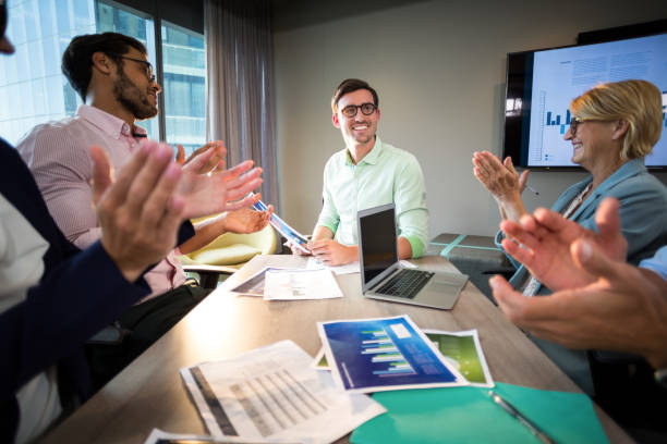 istock Coworkers applauding a colleague after presentation 660475618
