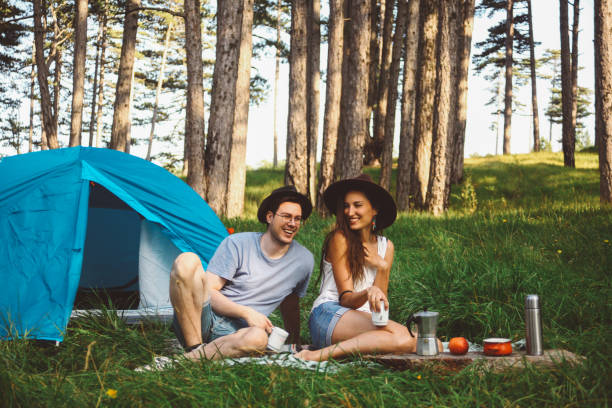 istock Young couple camping in the forest 660479380