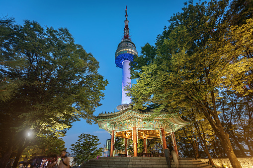 Illuminated famous Golden Pavilion at Night with N Seoul Tower in the background. Namsan Park, Seoul, South Korea, Asia.