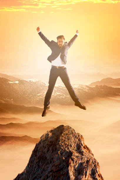 istock Businessman Jumping on Mountain Peak 660486666
