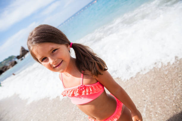 Little girl is at the beach enjoying the vacation