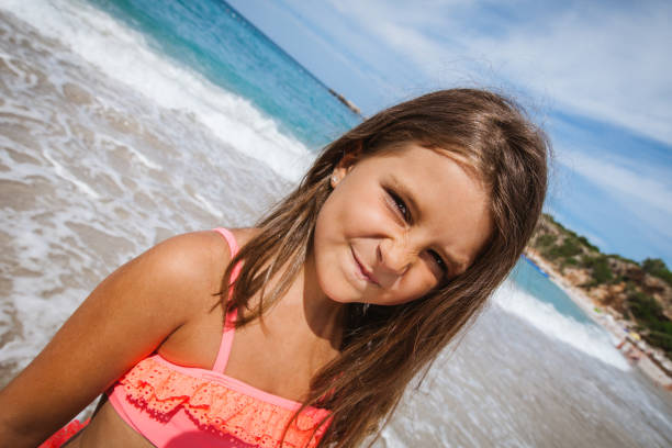 Little girl is at the beach enjoying the vacation