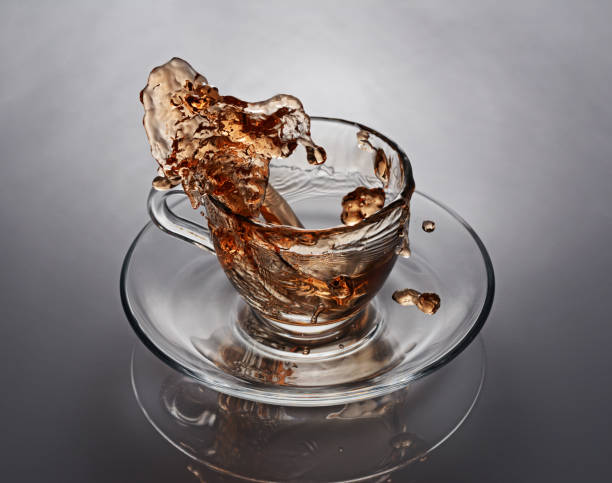 Splash in glass cup of black tea