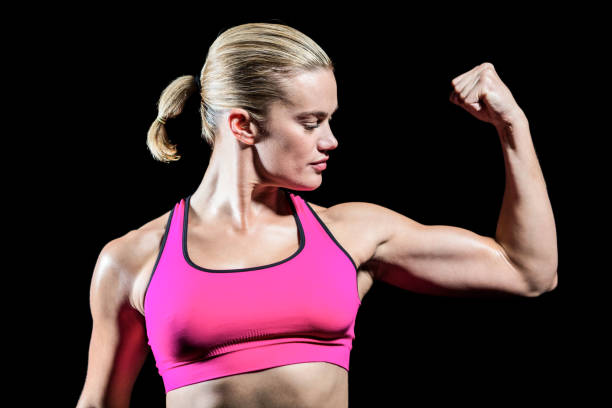 istock Muscular woman flexing her arm 660504272