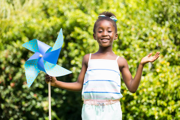istock Cute mixed-race girl smiling and holding a windmill 660506718