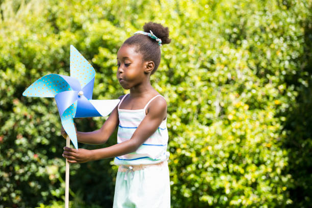 istock Cute mixed-race girl playing with a windmill 660506778