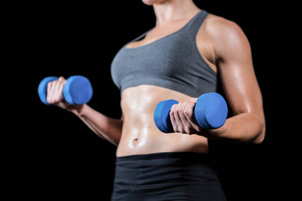istock Muscular woman lifting heavy dumbbells 660507068