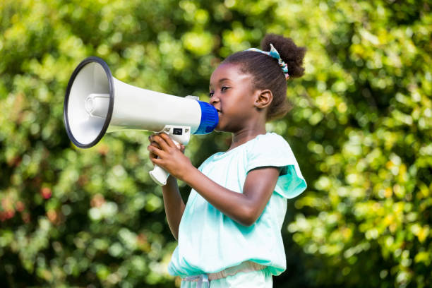 istock Cute mixed-race girl speaking on a megaphone 660510128