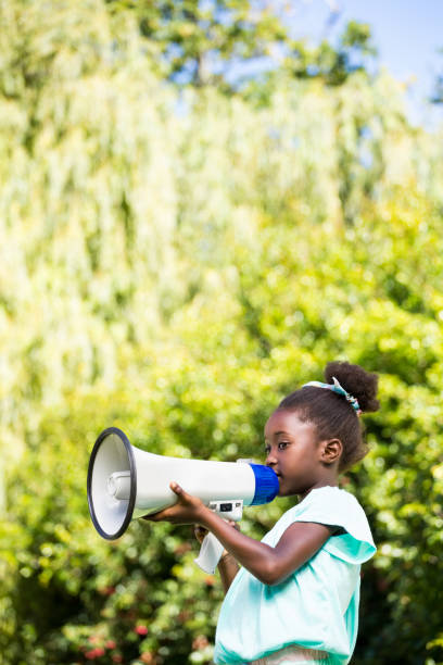 istock Cute mixed-race girl speaking on a megaphone 660510154
