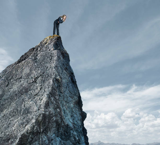 istock Businesswoman Looking Down From Mountain Top 660520620