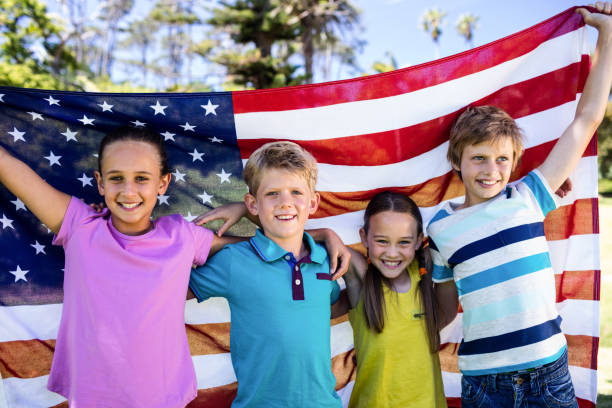 istock Children holding american flag in park 660526754