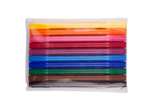 top view of transparent plastic packaging of a set of colored markers isolated on white background