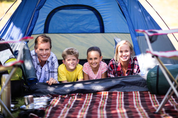 istock Happy family lying in a tent 660530338