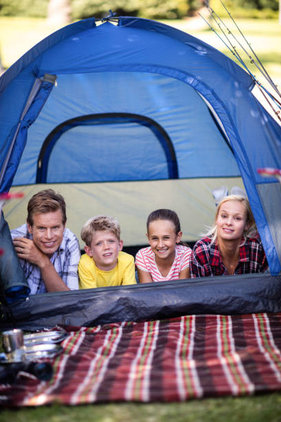istock Happy family lying in a tent 660530384