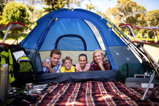 istock Happy family lying in a tent 660530452