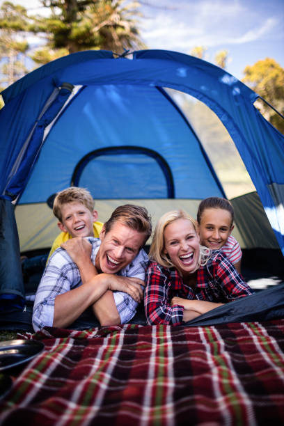 istock Happy family lying in a tent 660530596