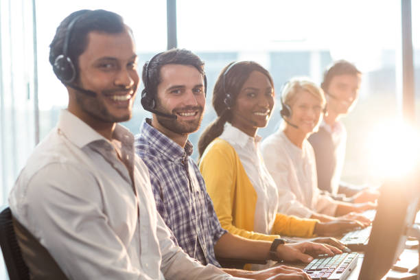 istock Team of colleagues working at their desk with headset 660533384