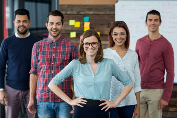 istock Smiling businesspeople standing in office 660540264