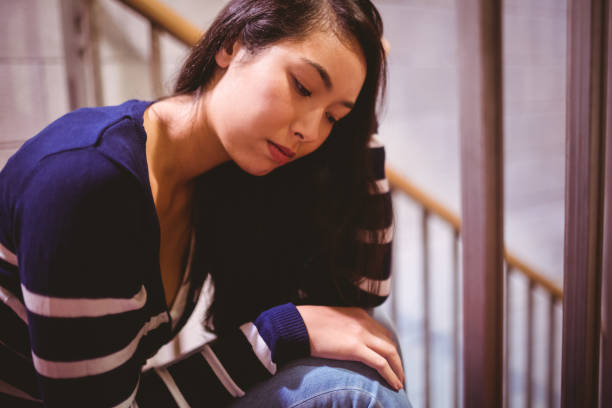 istock Worried student sitting in hallway 660541124