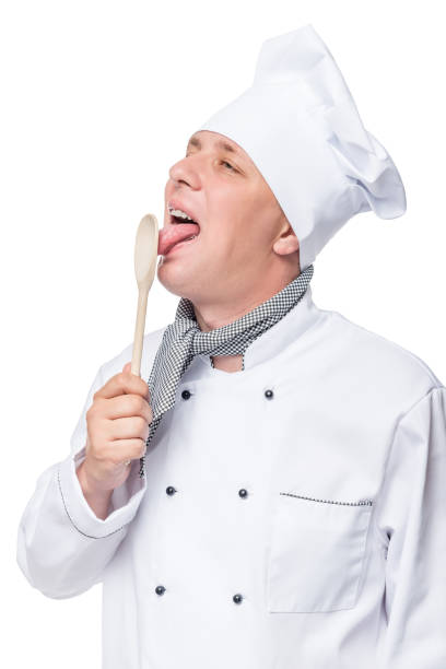 istock chef licks a wooden spoon, portrait isolated on white background 660541356