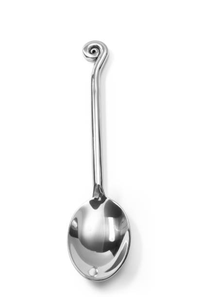 istock beautiful Stainless steel glossy metal kitchen spoon isolated 660544098