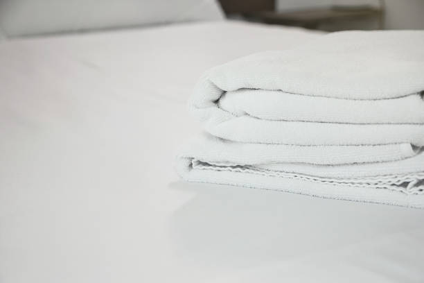 istock white towel on white mattress fabric, soft light in the morning 660550390