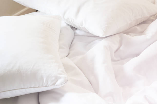 istock white pillow on bed and with wrinkle messy blanket in bedroom, from sleeping in a long night. 660550466