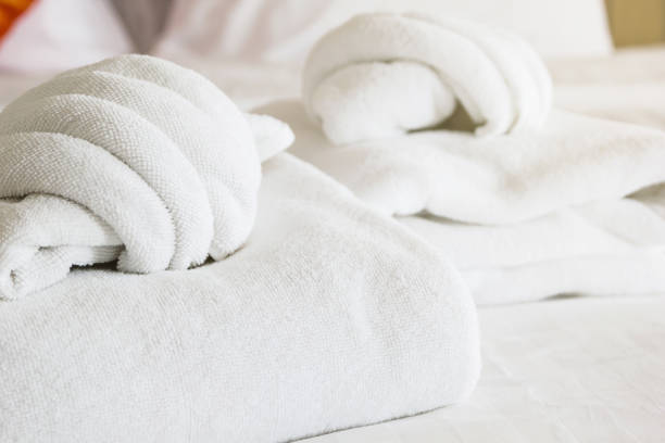 istock white towel on white mattress fabric, soft light in the morning 660550486