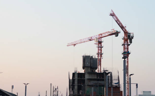 istock Abstract Industrial background with construction cranes silhouettes over amazing sunset sky 660550844