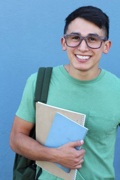 istock Teen holding notebooks and backpack smiling 660551244