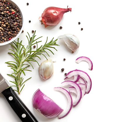 Food background top view, with red onion, rosemary, garlic, peppercorns, isolated on white.