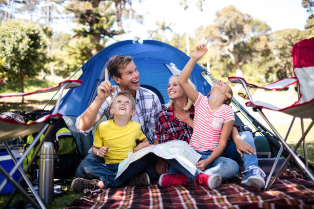 istock Family sitting in front of a tent 660563854