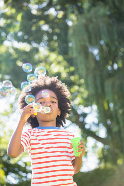 istock Portrait of boy making bubbles with bubble wand 660566622