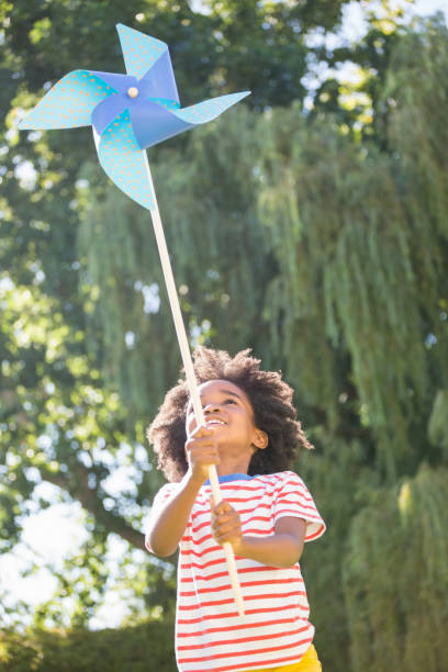 istock Happy boy is playing with pinwheel 660566656