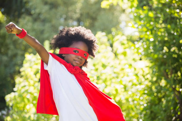 istock Boy dressed as a super hero in a park 660566990