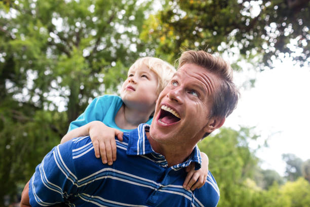 istock Happy man giving piggyback to his son 660569520