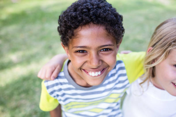 istock Happy boy standing in park 660569636