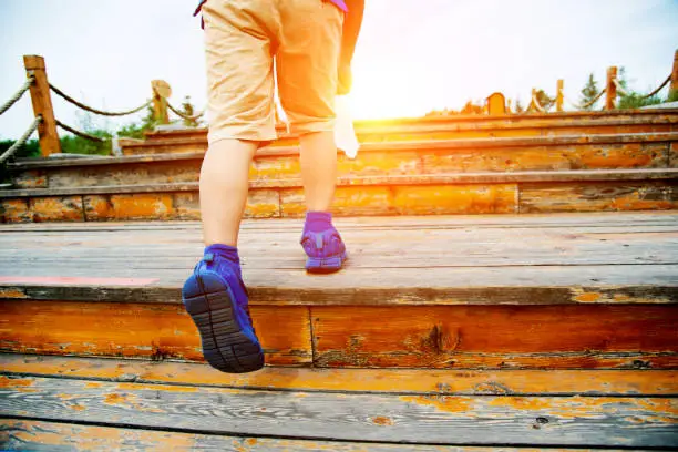 Photo of Boy walking upstairs outdoors