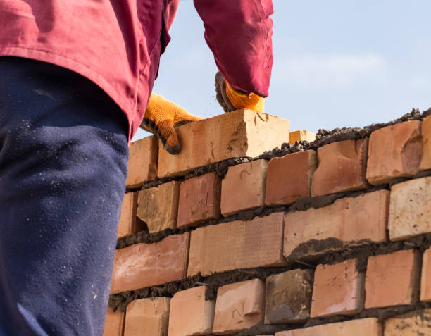 istock Worker builds a brick wall in the house 660570380