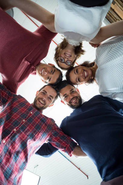 istock Team of businesspeople forming huddle 660572712