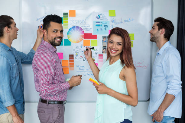 istock Business executives discussing over white board in office 660573574