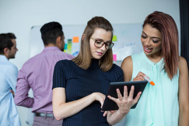 istock Business executives discussing over digital tablet 660573830