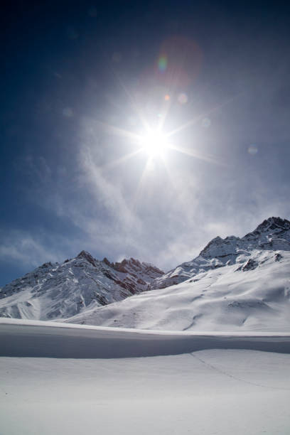 istock Sun shining with lens flare over snowcapped Himalayas mountain 660583554