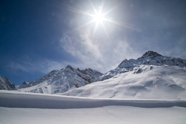 istock Sun shining with lens flare over snowcapped Himalayas mountain 660583676