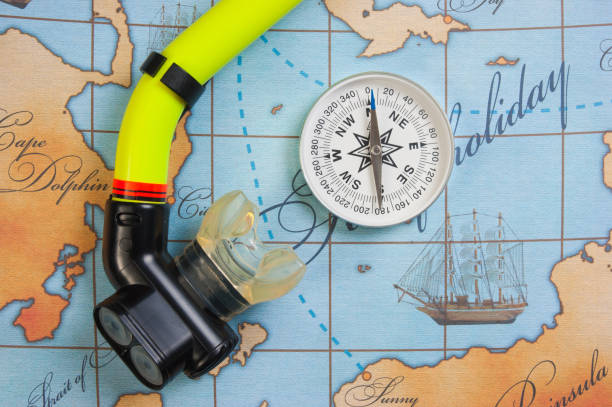 istock swimming accessories and items for leisure travel on  background map 660590168
