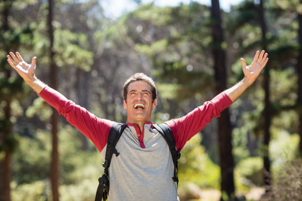 istock Man smiling and throwing up arms 660591062
