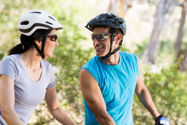 istock Couple looking each other with their bikes 660594360