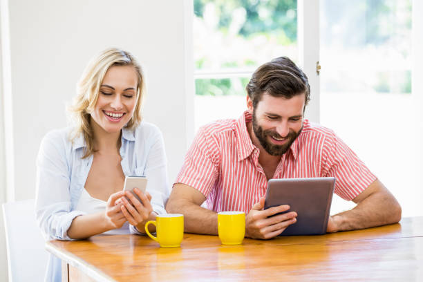 istock Young couple using digital tablet and mobile phone 660603636